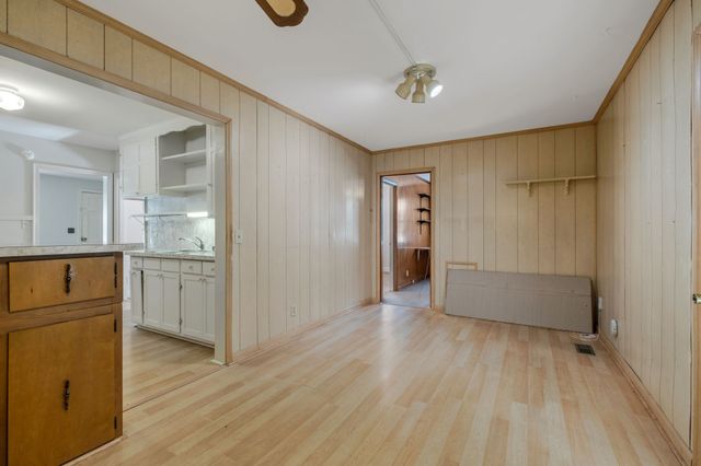 a view of a kitchen with a sink cabinets and wooden floor