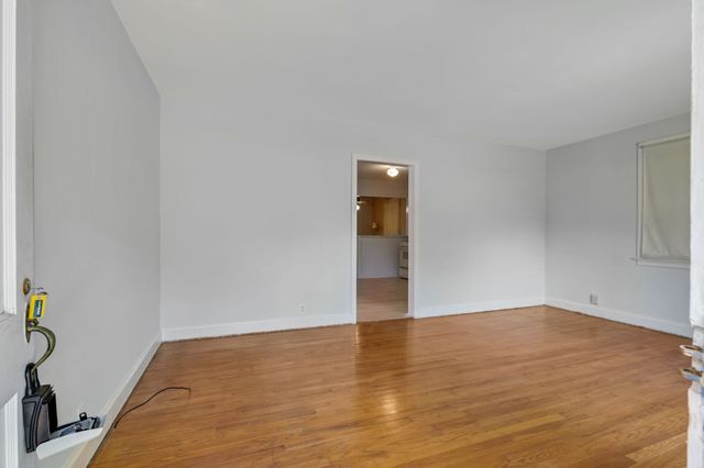 a view of an empty room and wooden floor