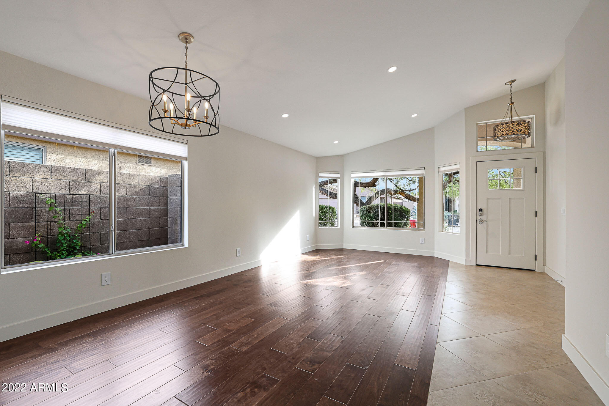 4316 East Rowel Road Phoenix, AZ 85050 - Photo 12 of 40 a view of an empty room with wooden floor and a window