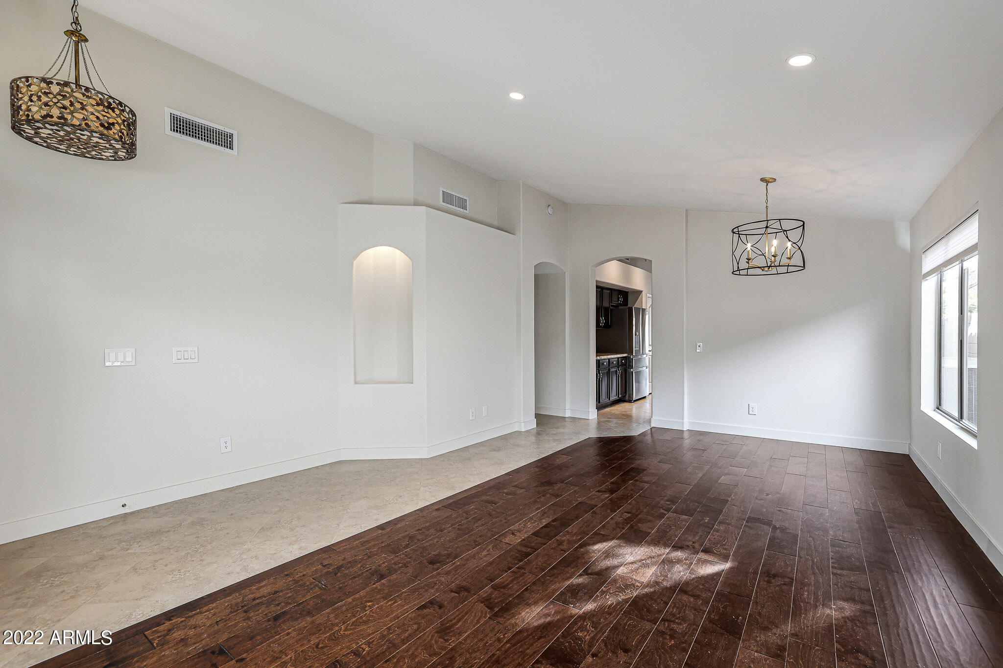 4316 East Rowel Road Phoenix, AZ 85050 - Photo 13 of 40 a view of an empty room with a window and wooden floor