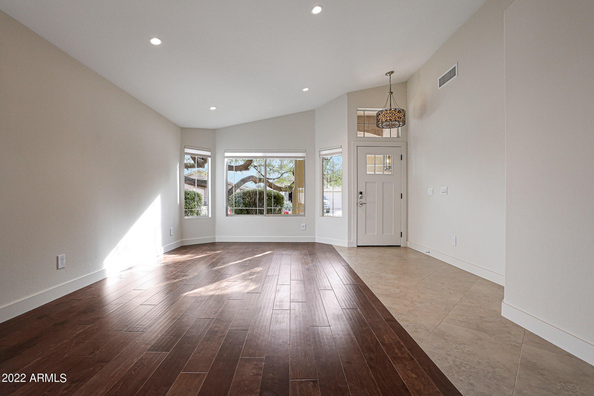 4316 East Rowel Road Phoenix, AZ 85050 - Photo 14 of 40 an empty room with wooden floor and windows