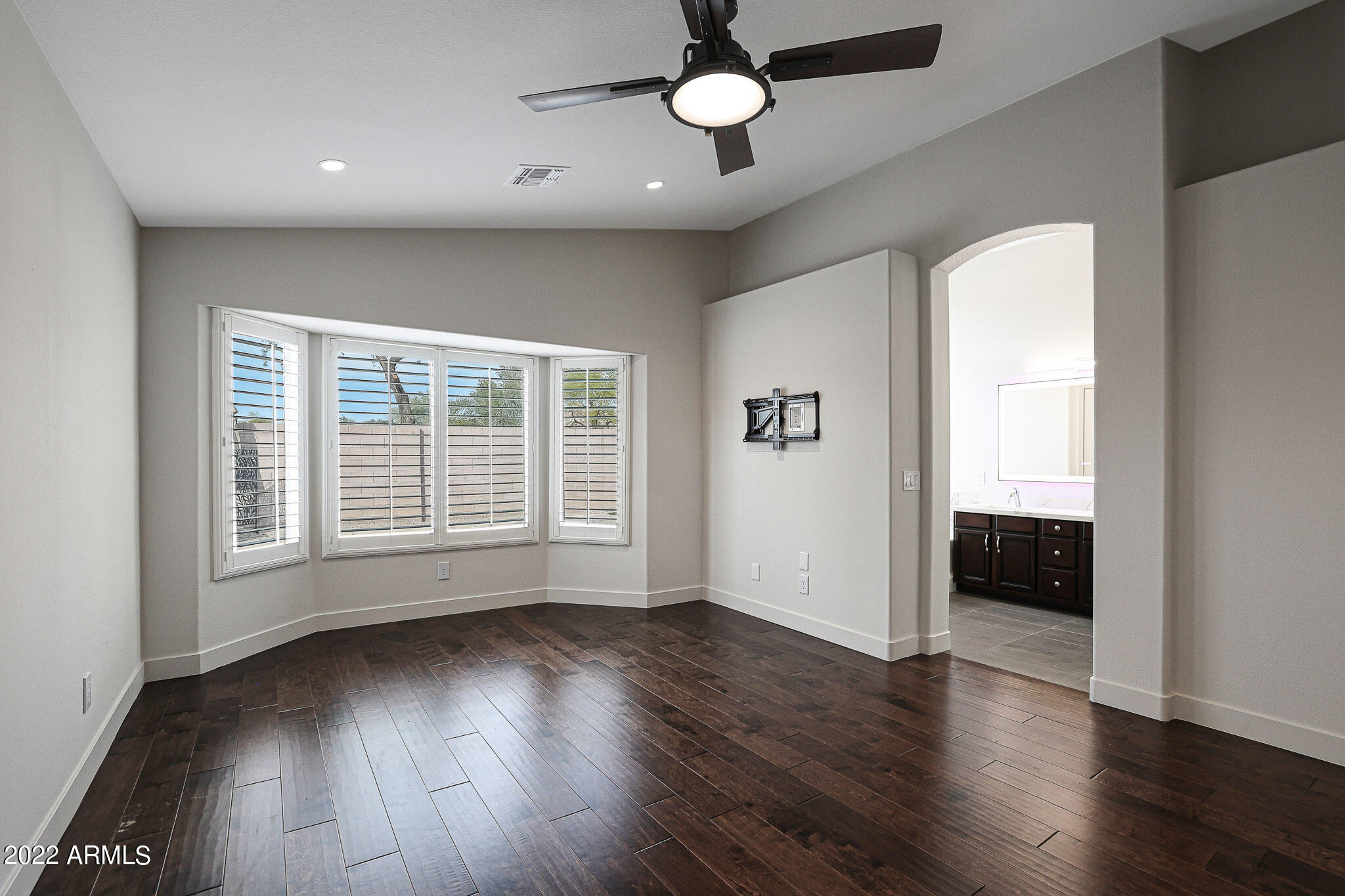 4316 East Rowel Road Phoenix, AZ 85050 - Photo 16 of 40 a view of an empty room with wooden floor and a window