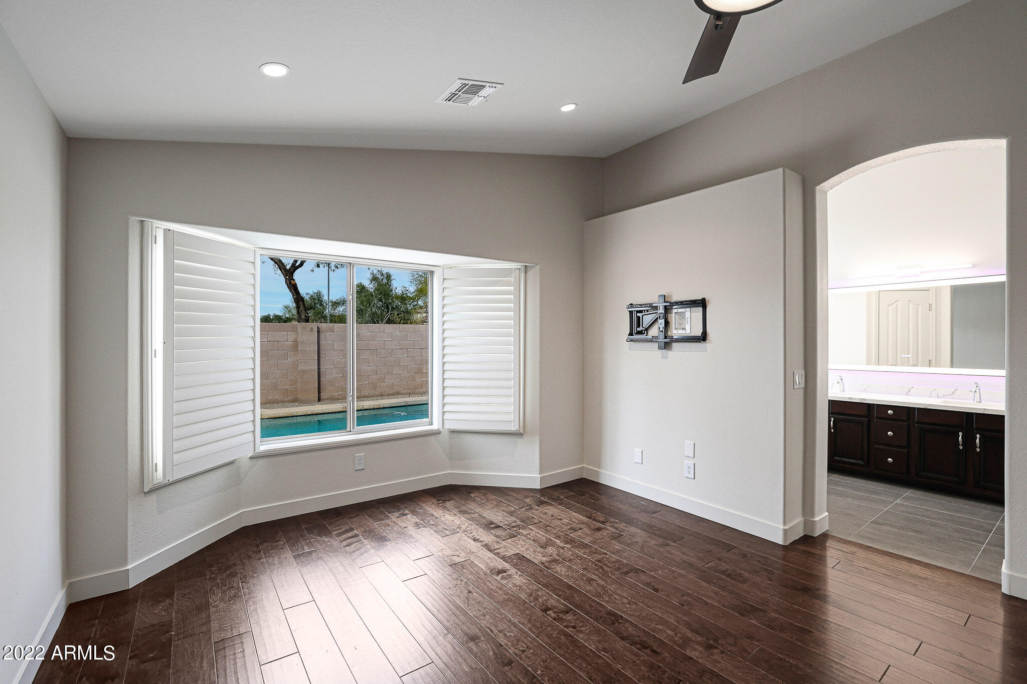 4316 East Rowel Road Phoenix, AZ 85050 - Photo 17 of 40 an empty room with wooden floor and windows