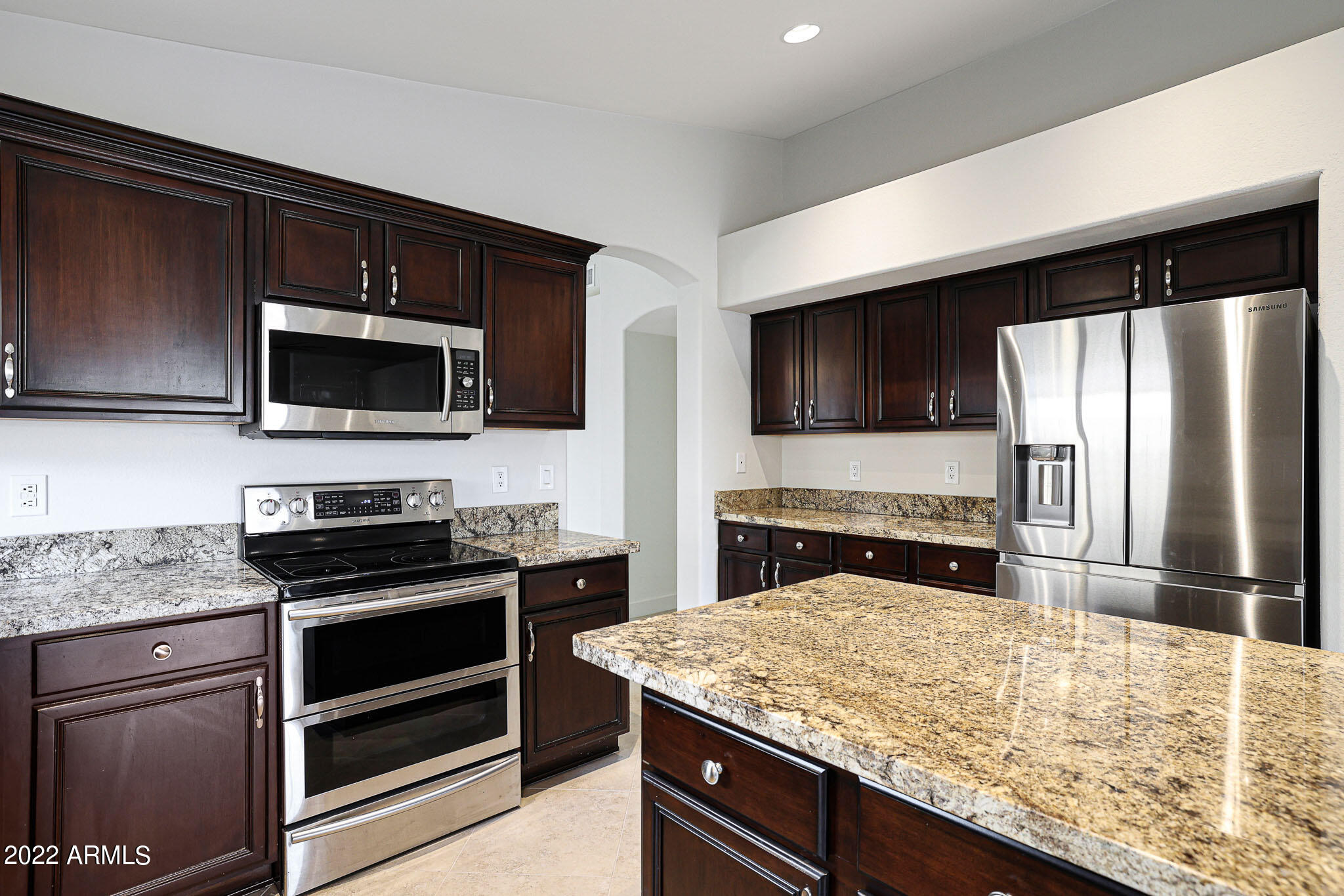 4316 East Rowel Road Phoenix, AZ 85050 - Photo 2 of 40 a kitchen with granite countertop a stove and a microwave