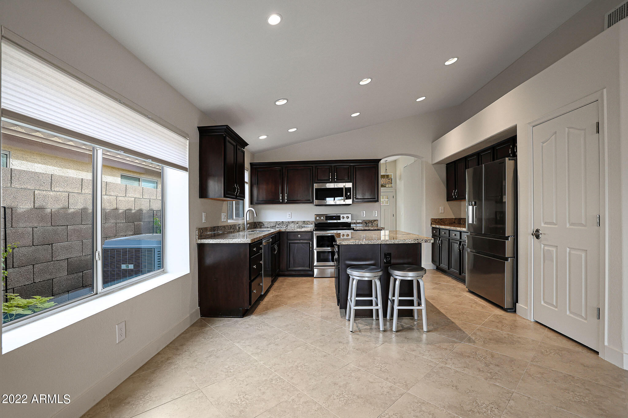 4316 East Rowel Road Phoenix, AZ 85050 - Photo 4 of 40 a kitchen with a sink a counter top space stainless steel appliances and a dining table