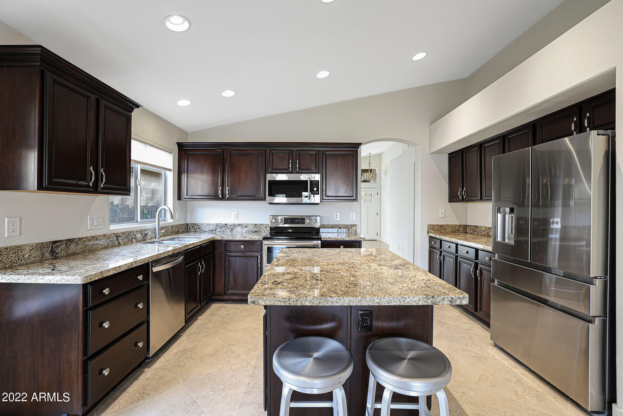 4316 East Rowel Road Phoenix, AZ 85050 - Photo 5 of 40 a kitchen with kitchen island granite countertop wooden cabinets and stainless steel appliances