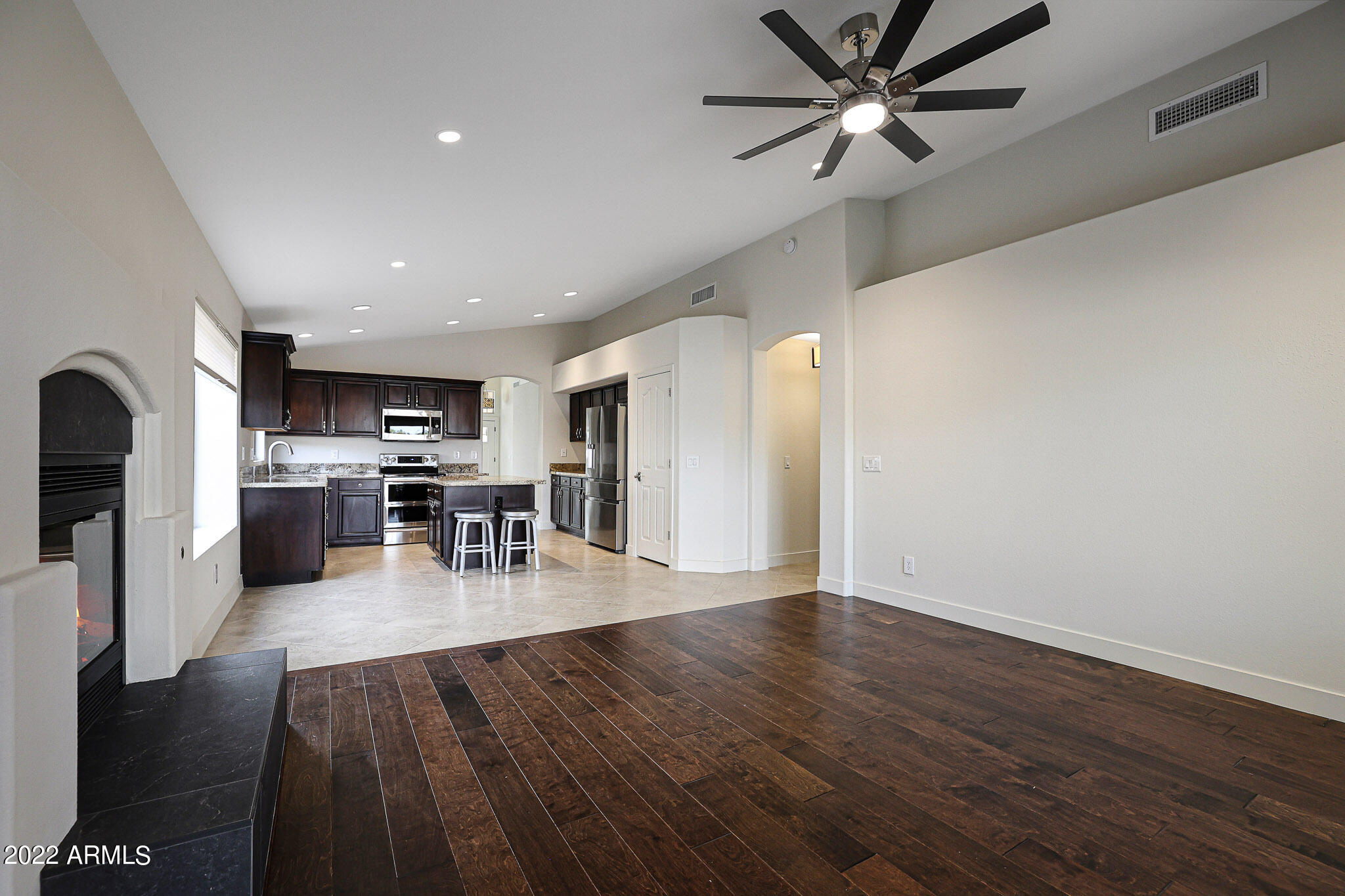 4316 East Rowel Road Phoenix, AZ 85050 - Photo 10 of 40 a view of a kitchen with dining table chairs and wooden floor