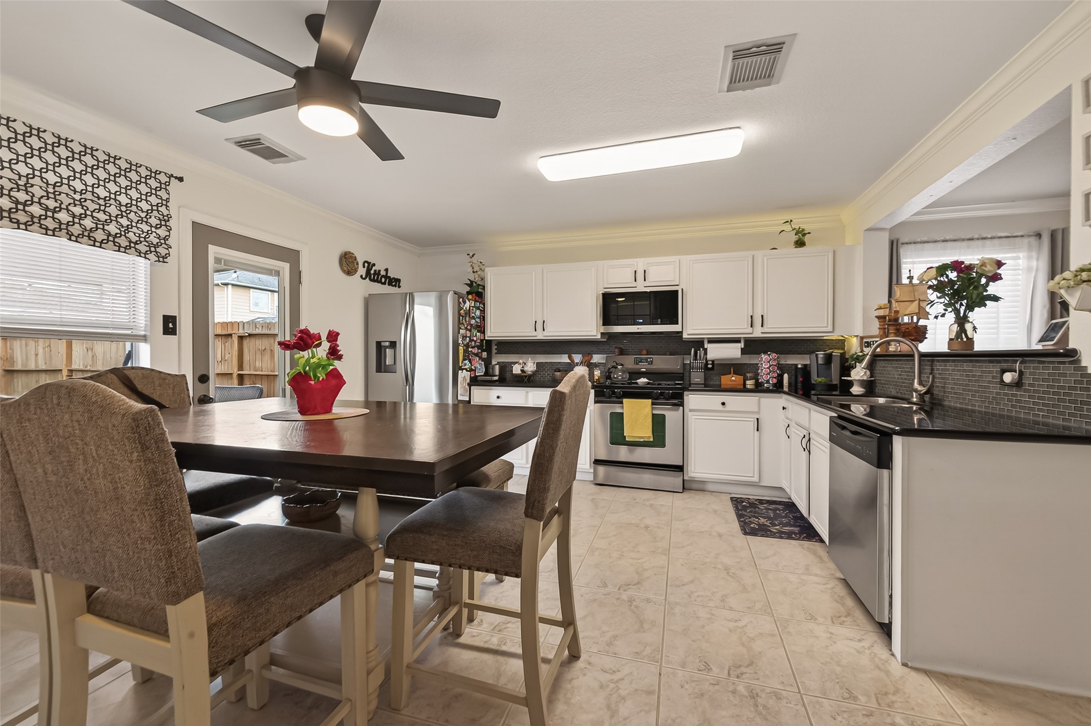 9902 Victoria Point Lane Houston, TX 77075 - Photo 7 of 35 This inviting kitchen and breakfast area features modern stainless steel appliances, ample counter space, and a cozy dining nook perfect for family gatherings.