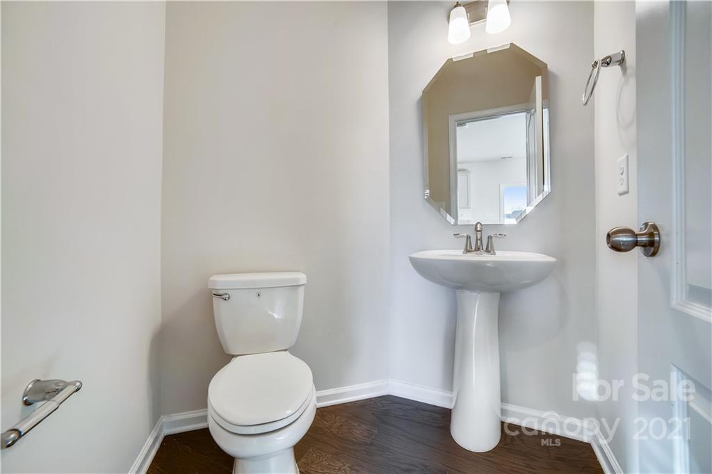 18121 Kalabash Road, Unit 195 Charlotte, NC 28278 - Photo 16 of 39 a bathroom with a toilet sink and mirror