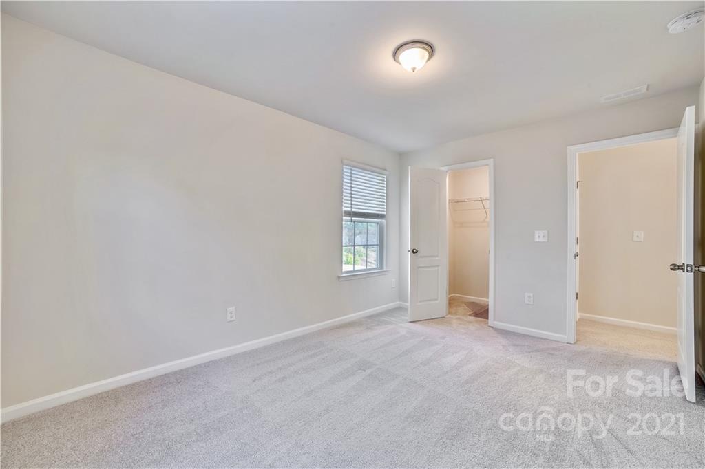 18121 Kalabash Road, Unit 195 Charlotte, NC 28278 - Photo 24 of 39 an empty room with windows and closet
