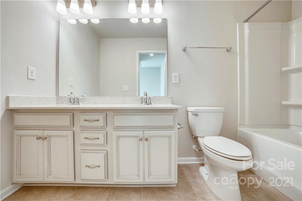 18121 Kalabash Road, Unit 195 Charlotte, NC 28278 - Photo 25 of 39 a bathroom with a sink a toilet and shower