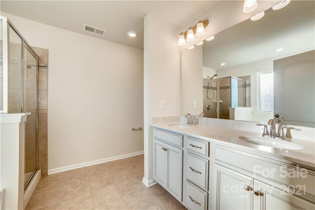 18121 Kalabash Road, Unit 195 Charlotte, NC 28278 - Photo 29 of 39 a bathroom with a double vanity sink and a mirror