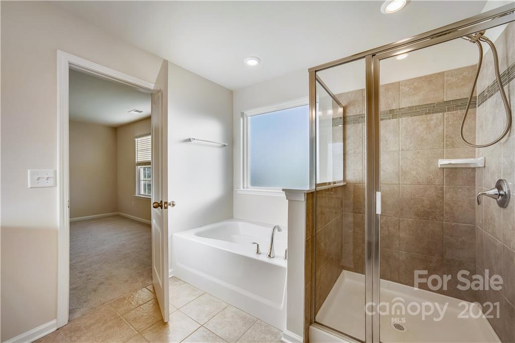 18121 Kalabash Road, Unit 195 Charlotte, NC 28278 - Photo 30 of 39 a bathroom with a tub and shower