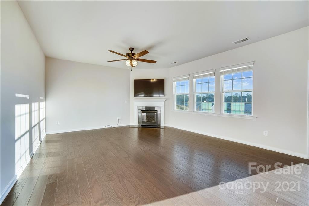 18121 Kalabash Road, Unit 195 Charlotte, NC 28278 - Photo 10 of 39 a view of an empty room with a window and wooden floor