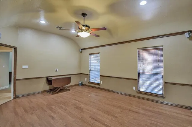 an empty room with a ceiling fan and a ceiling fan