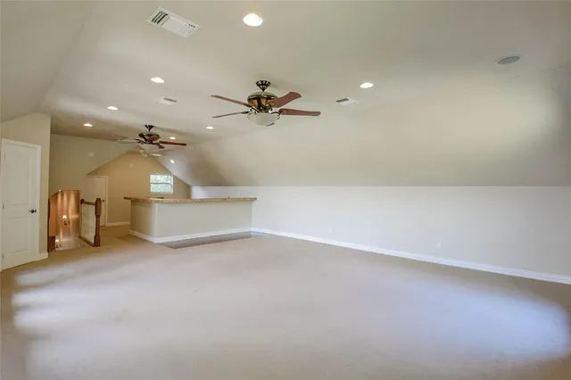 a kitchen with a sink dishwasher a dining table and chairs with wooden floor