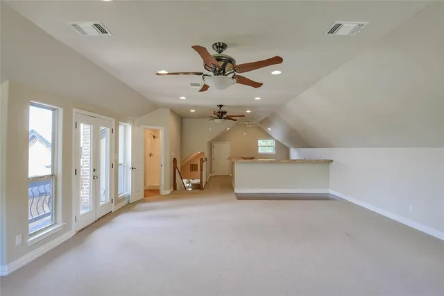 a view of a livingroom with a ceiling fan and window