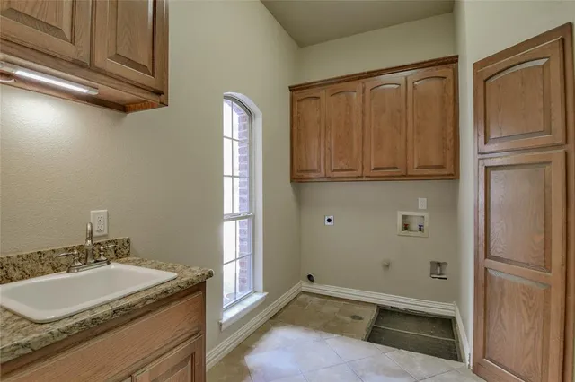 a view of a city with flower plants and wooden fence