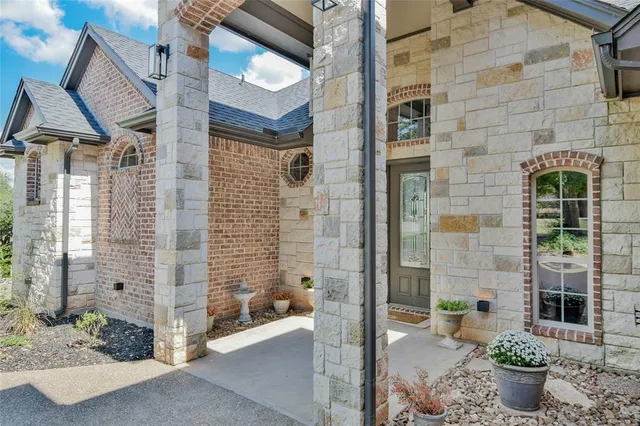 a front view of a house with a garden and yard
