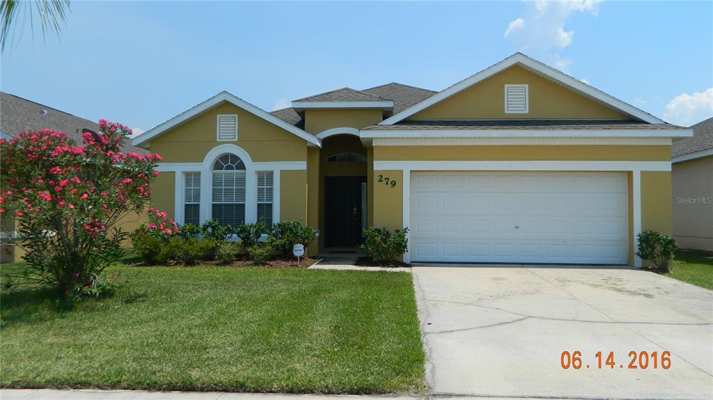 279 Magical Way Kissimmee, FL 34744 - Photo 1 of 1 a front view of a house with a yard