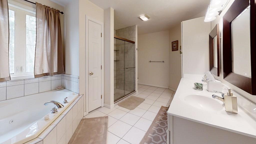 23 Tannery Road Sturbridge, MA 01518 - Photo 25 of 41 a bathroom with a tub sink and a mirror