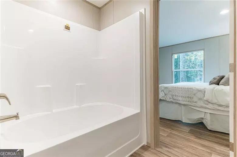 643 Old Ridge Road Demorest, GA 30535 - Photo 47 of 56 a bathroom with a bathtub and a shower