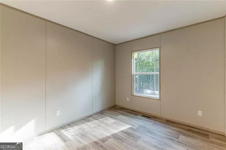 643 Old Ridge Road Demorest, GA 30535 - Photo 50 of 56 an empty room with wooden floor and windows