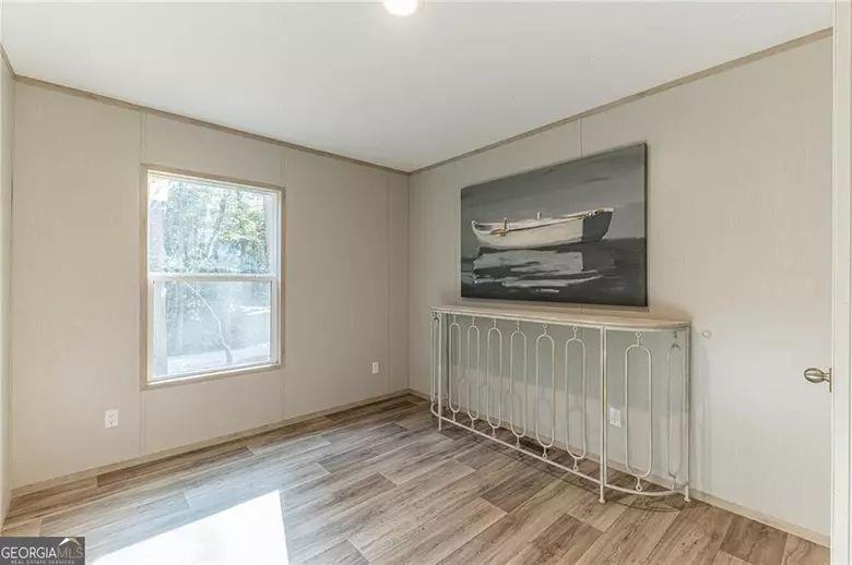 643 Old Ridge Road Demorest, GA 30535 - Photo 52 of 56 a view of an empty room with wooden floor and a window