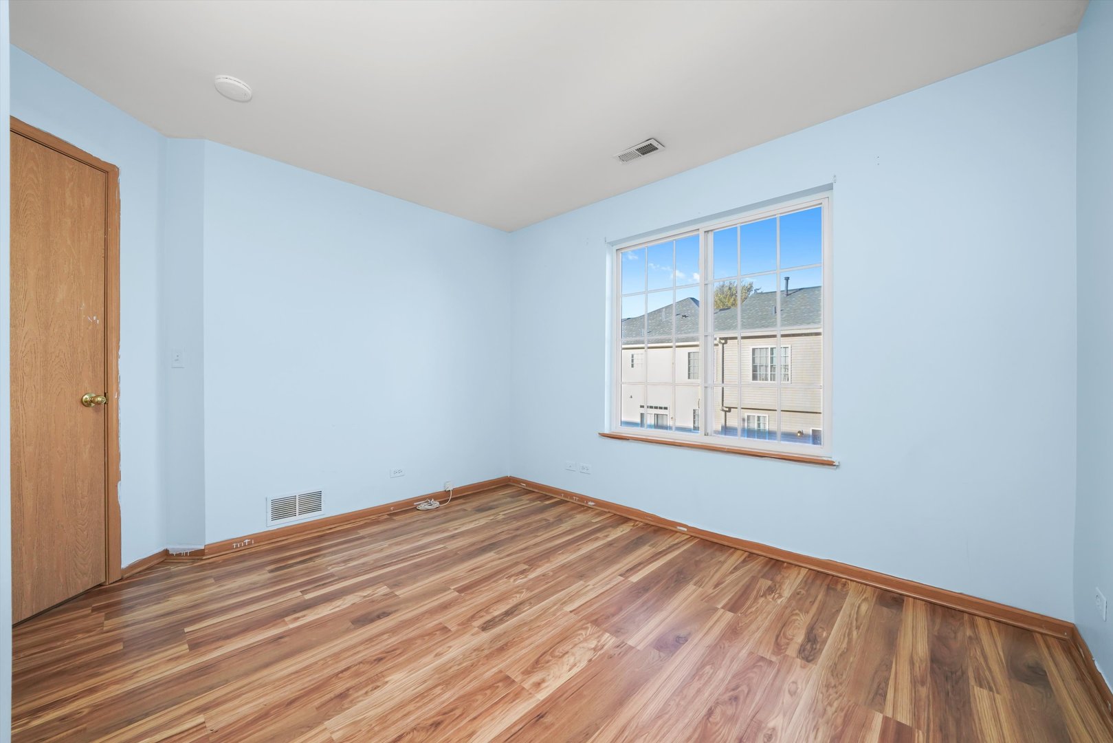409 Evergreen Circle, Unit 4 Gilberts, IL 60136 - Photo 15 of 42 a view of a room with a wooden floor and a window