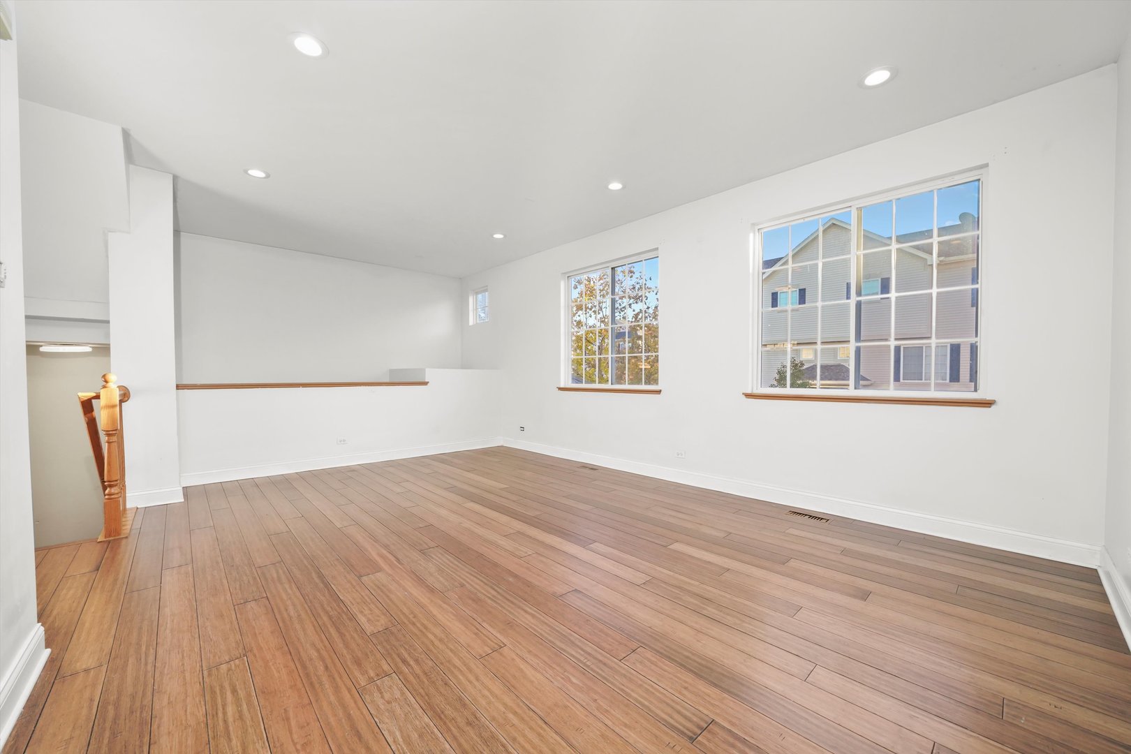 409 Evergreen Circle, Unit 4 Gilberts, IL 60136 - Photo 4 of 42 a view of empty room with wooden floor and fan