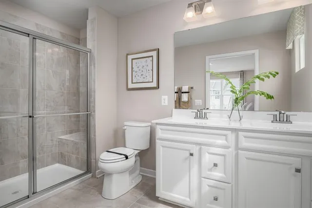 a bathroom with a toilet sink and shower