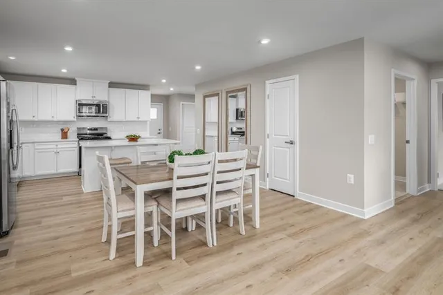 a kitchen with a table and chairs in it