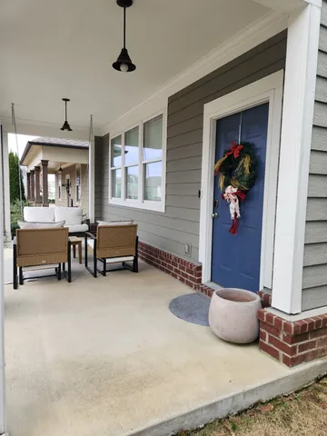 a living room with furniture and a lamp