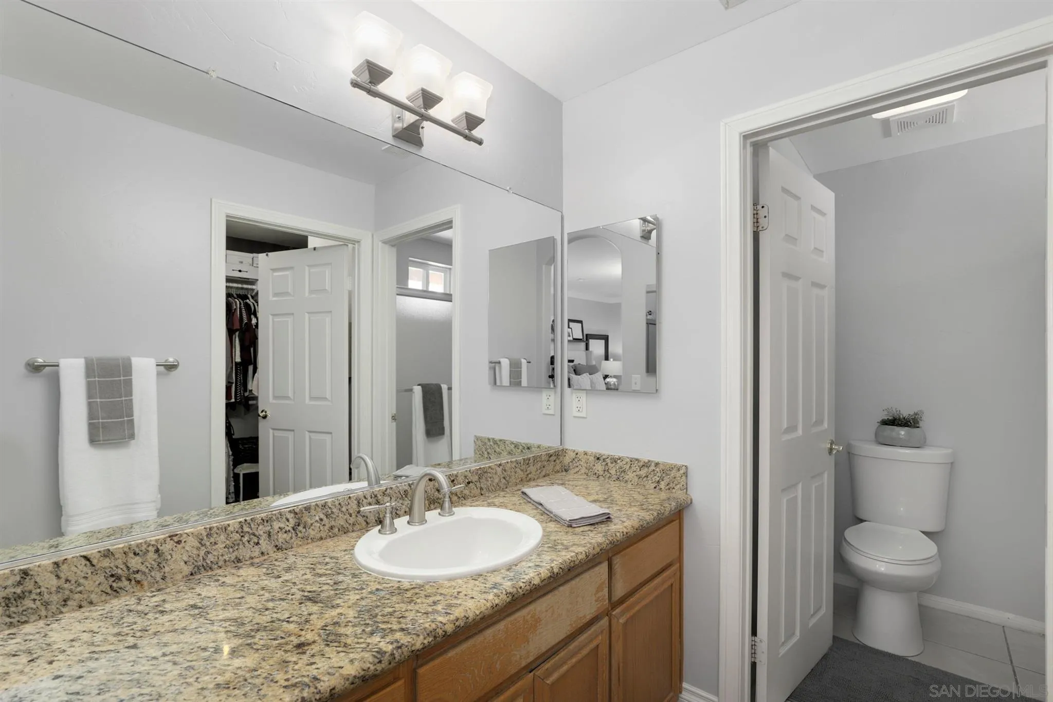 7949 Winter View Court El Cajon, CA 92021 - Photo 15 of 27 a bathroom with a granite countertop sink toilet and shower
