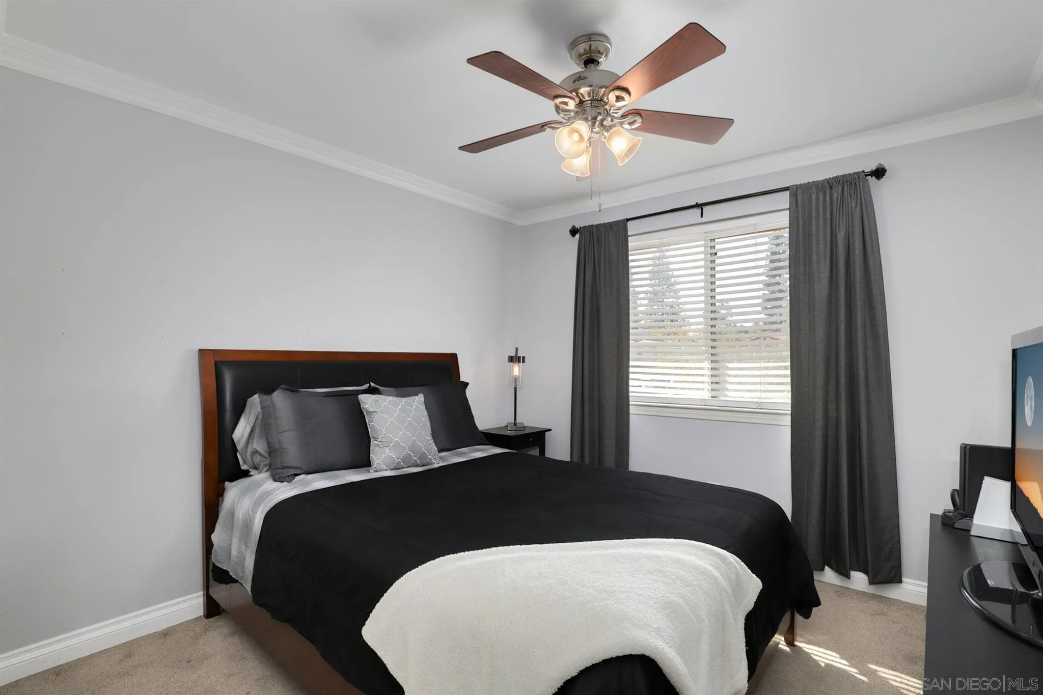 7949 Winter View Court El Cajon, CA 92021 - Photo 16 of 27 a bedroom with a large bed and a large window