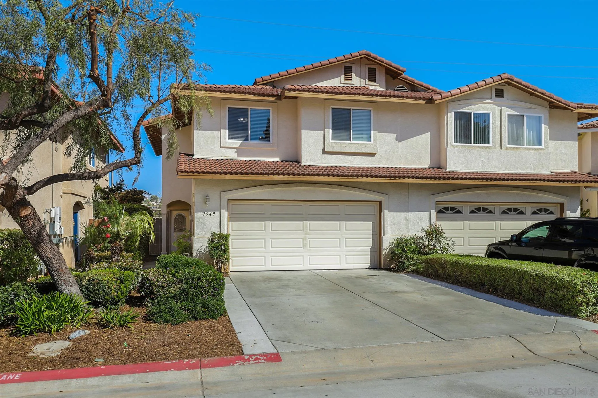 7949 Winter View Court El Cajon, CA 92021 - Photo 23 of 27 a front view of a house with a yard and garage