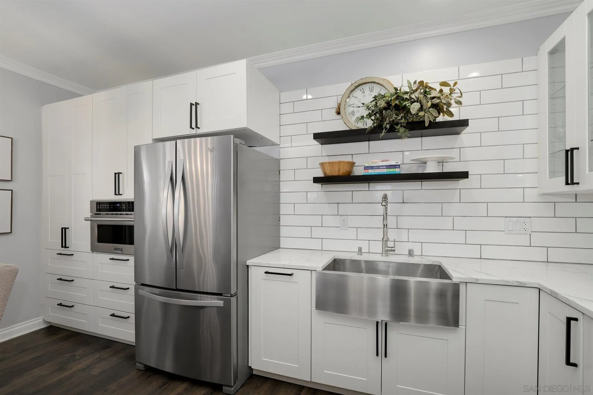 7949 Winter View Court El Cajon, CA 92021 - Photo 3 of 27 a kitchen with stainless steel appliances a refrigerator a stove a sink and white cabinets
