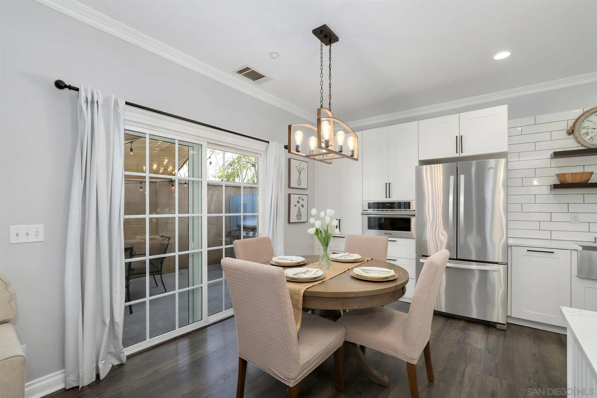 7949 Winter View Court El Cajon, CA 92021 - Photo 6 of 27 a kitchen with a refrigerator a table and chairs