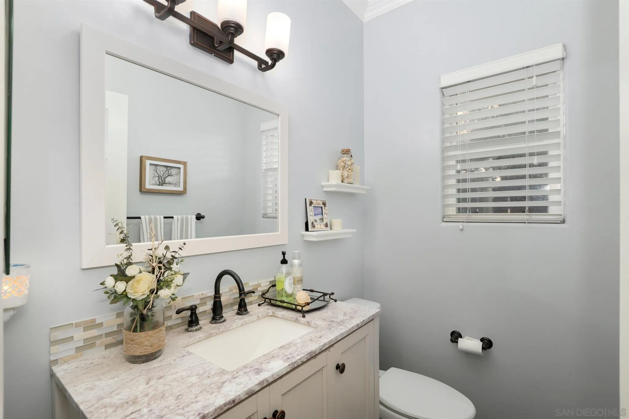 7949 Winter View Court El Cajon, CA 92021 - Photo 9 of 27 a bathroom with a granite countertop toilet sink and mirror
