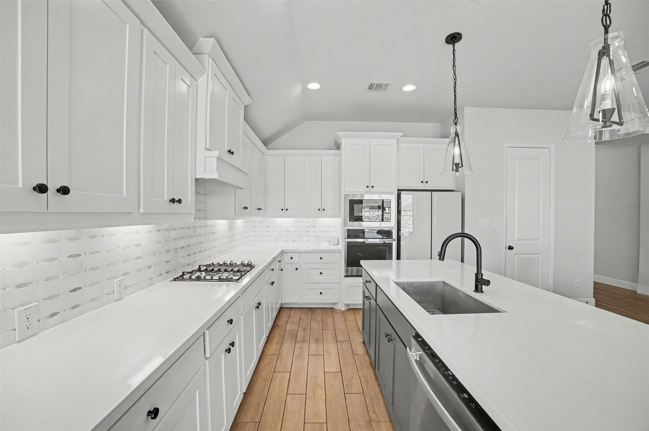 186 Prickly Poppy Loop Kyle, TX 78640 - Photo 9 of 40 a kitchen with a sink a stove and cabinets