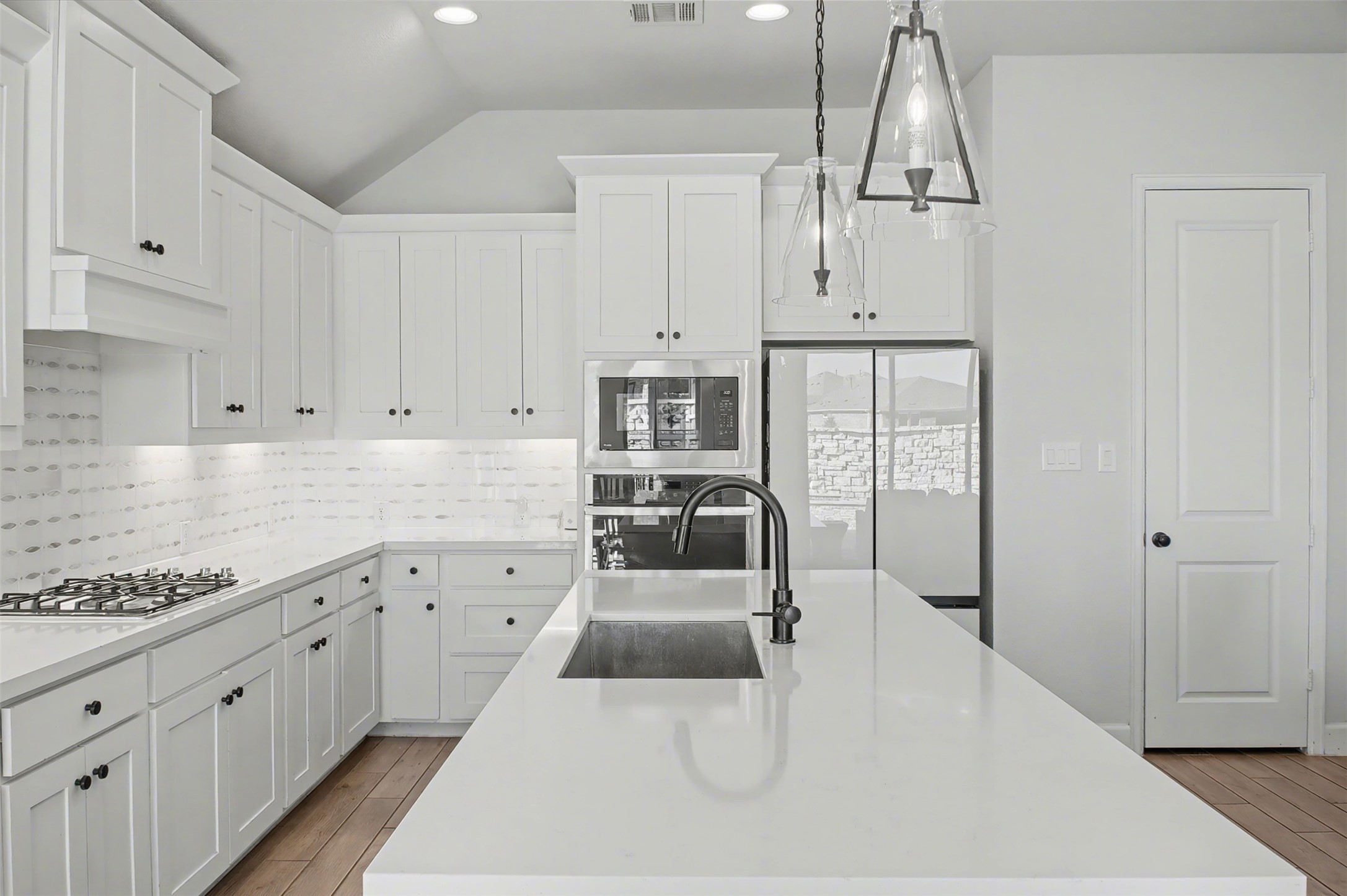 186 Prickly Poppy Loop Kyle, TX 78640 - Photo 10 of 40 a large white kitchen with cabinets