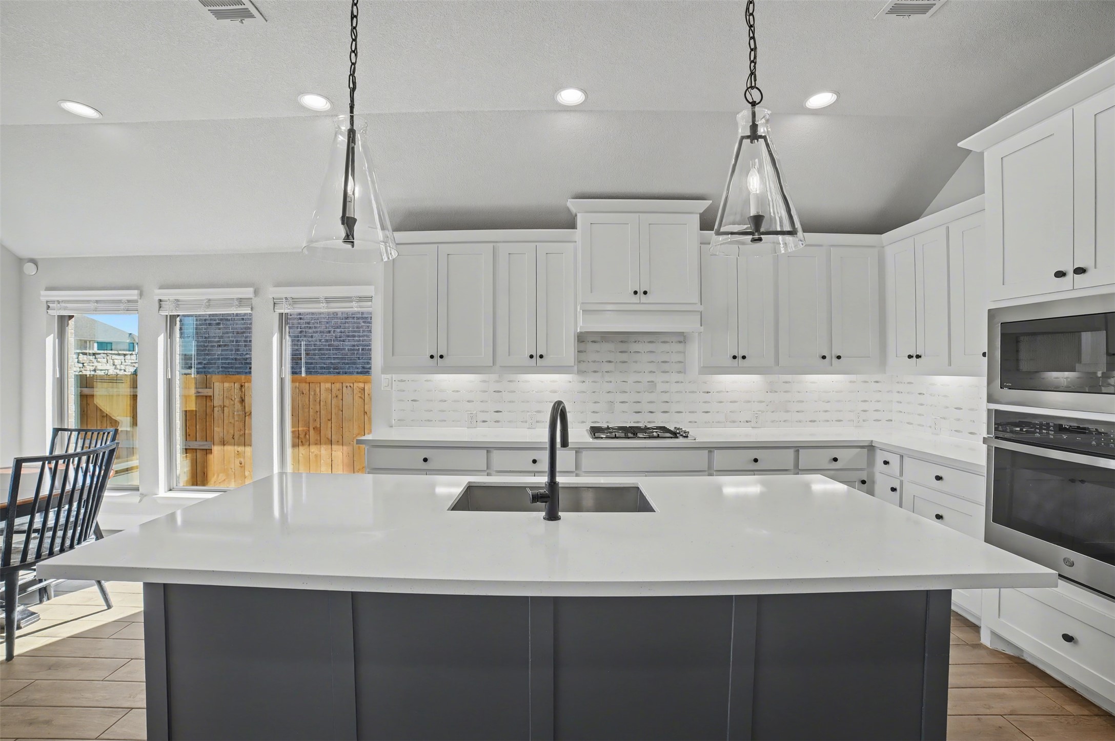 186 Prickly Poppy Loop Kyle, TX 78640 - Photo 11 of 40 a kitchen with kitchen island a sink stainless steel appliances and cabinets