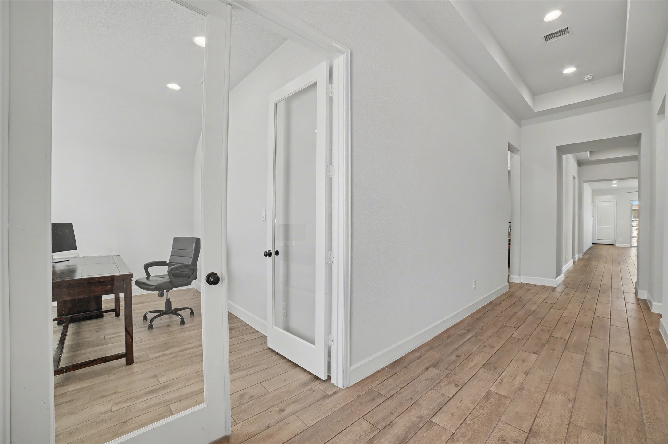 186 Prickly Poppy Loop Kyle, TX 78640 - Photo 12 of 40 a view of a room with wooden floor lounge chair and windows