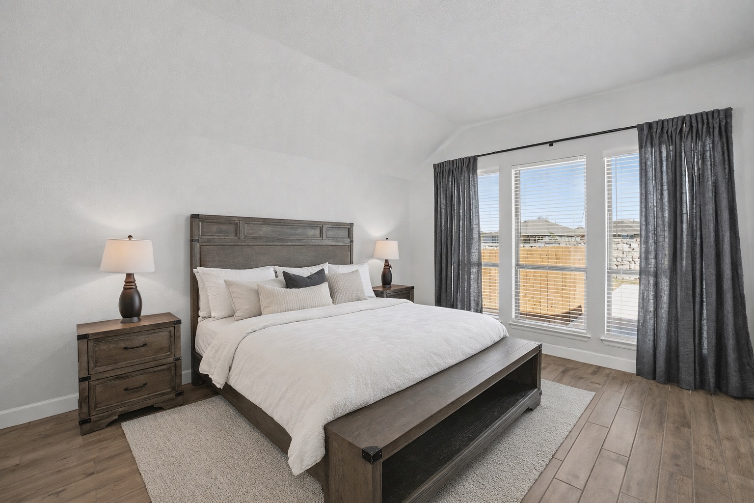 186 Prickly Poppy Loop Kyle, TX 78640 - Photo 17 of 40 a bedroom with a bed and wooden floor