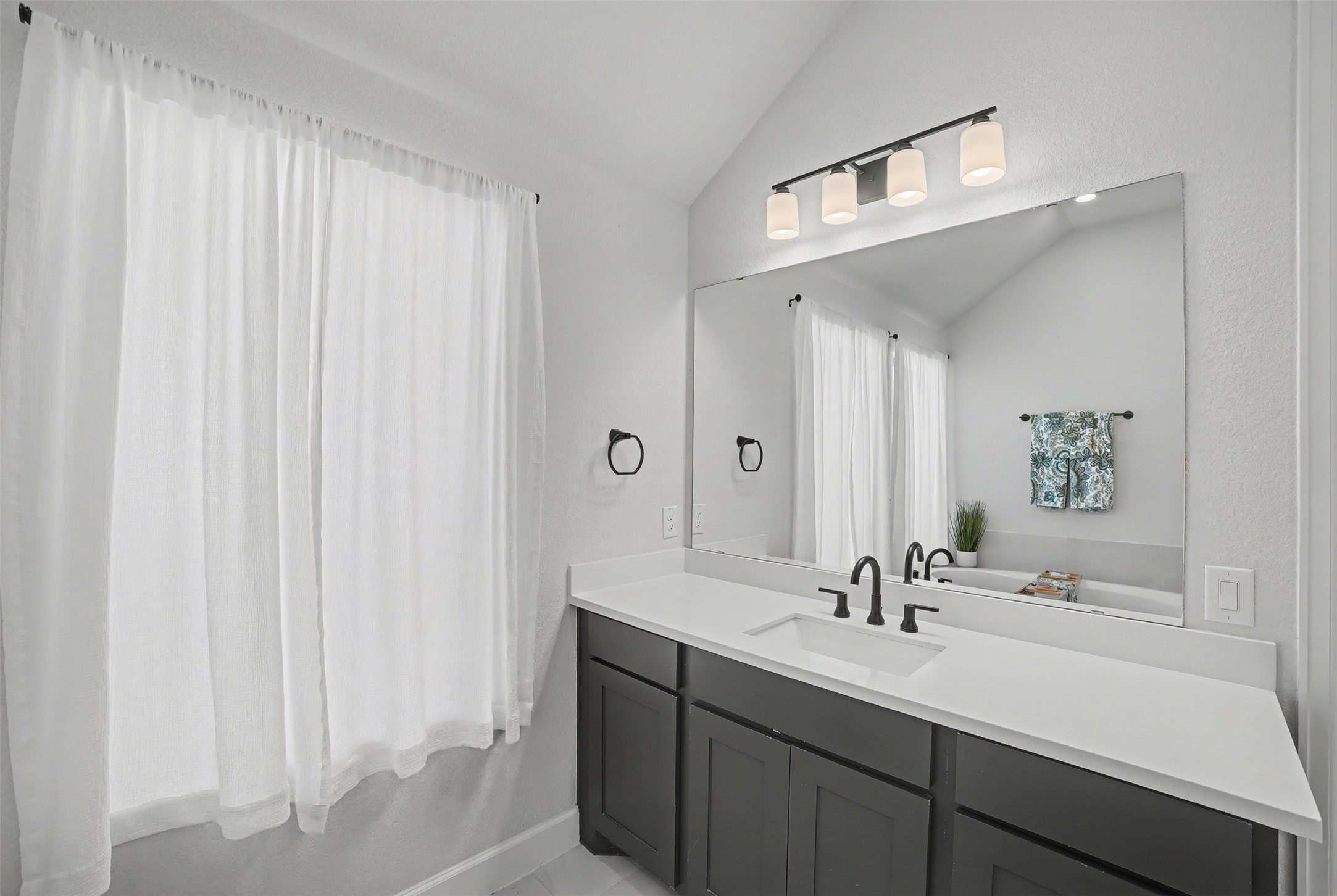 186 Prickly Poppy Loop Kyle, TX 78640 - Photo 19 of 40 a bathroom with a sink and a mirror