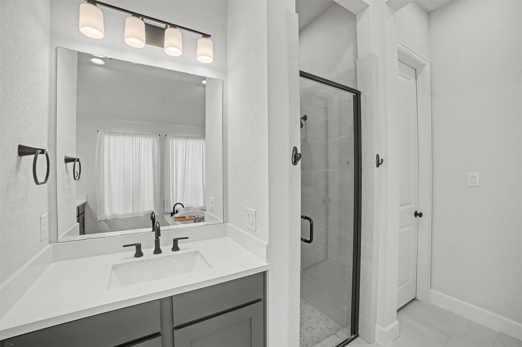 186 Prickly Poppy Loop Kyle, TX 78640 - Photo 20 of 40 a bathroom with a sink and a mirror