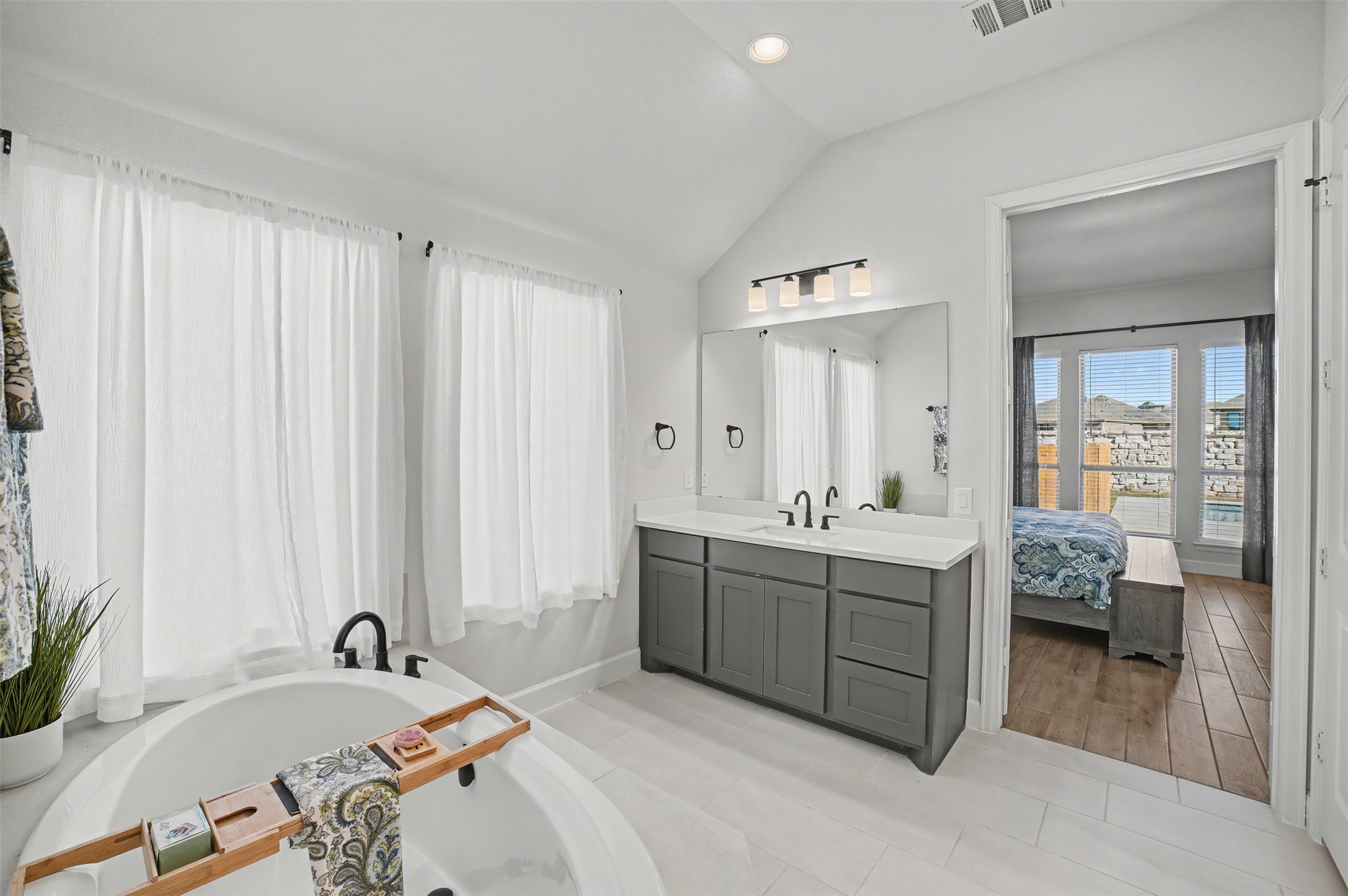 186 Prickly Poppy Loop Kyle, TX 78640 - Photo 22 of 40 a spacious bathroom with a tub sink and mirror