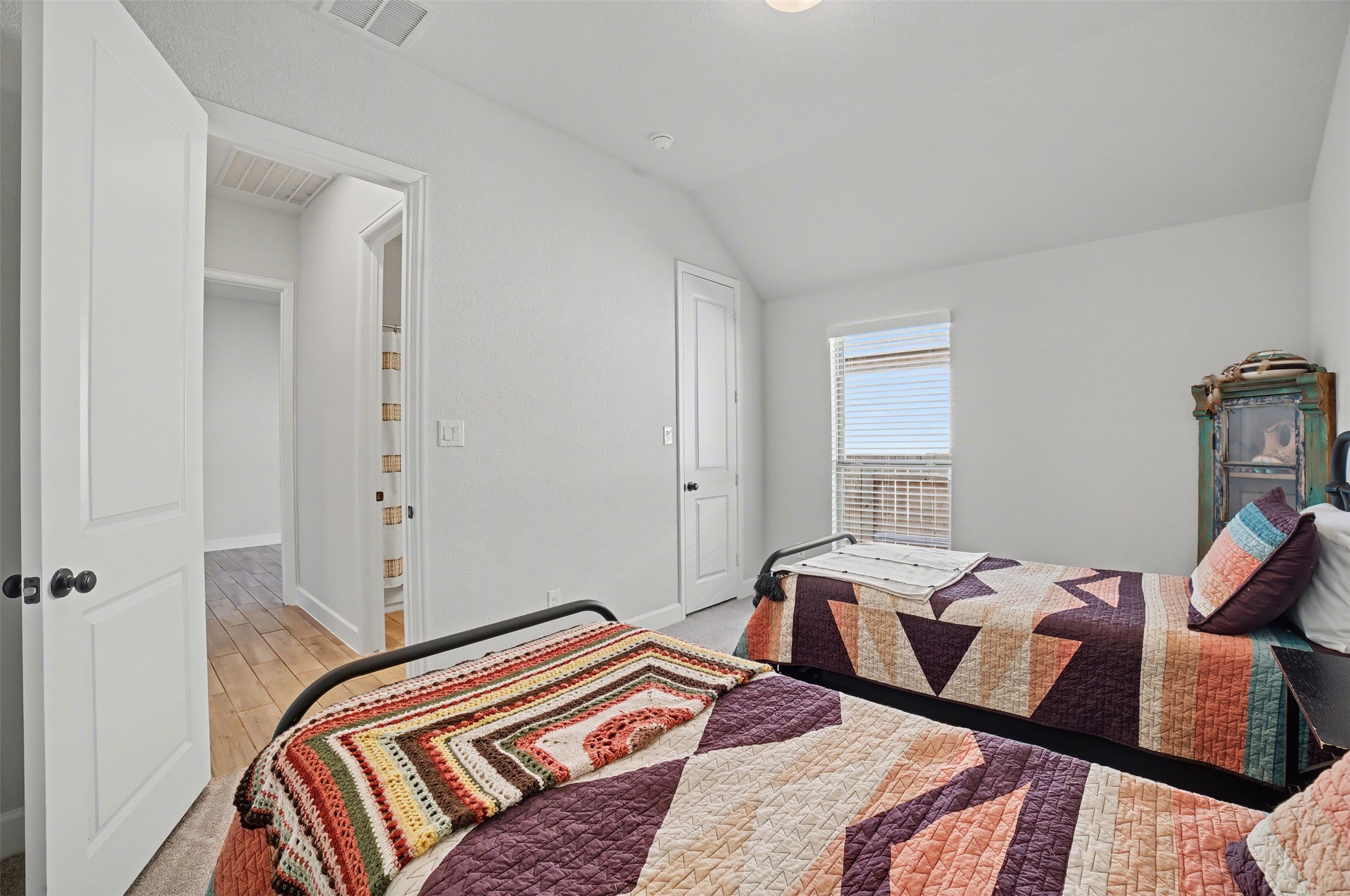 186 Prickly Poppy Loop Kyle, TX 78640 - Photo 26 of 40 a bedroom with two beds and a lamp