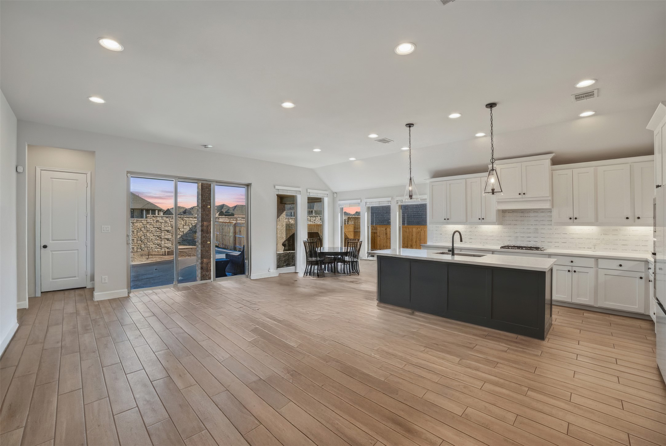 186 Prickly Poppy Loop Kyle, TX 78640 - Photo 3 of 40 a large kitchen with stainless steel appliances granite countertop a large counter top a stove and a wooden floors