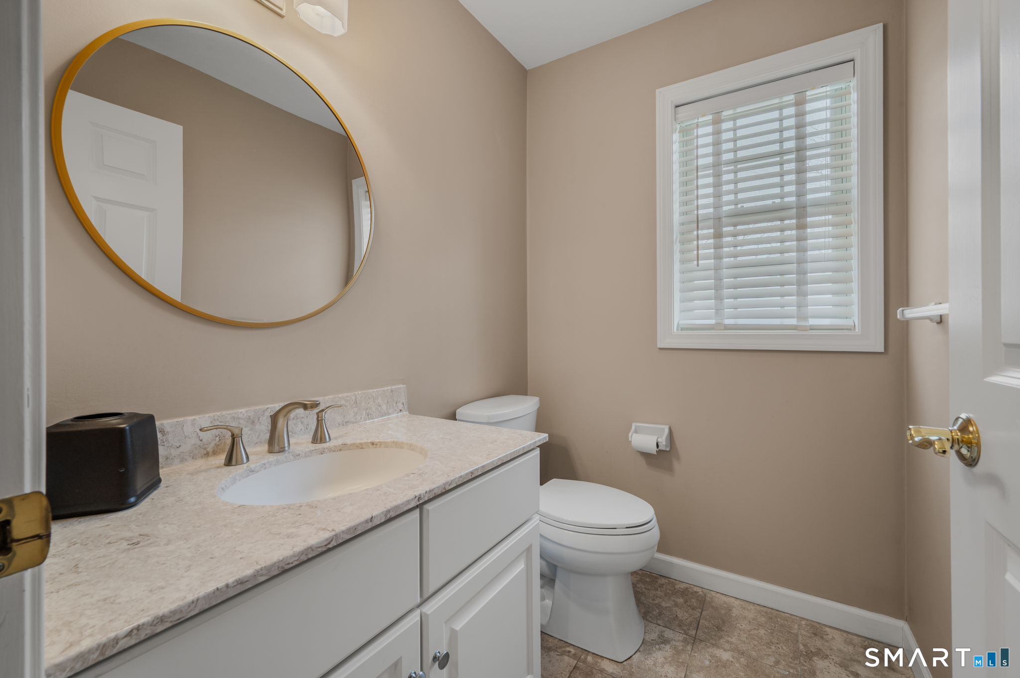1 Bittersweet Lane, Unit 1 East Lyme, CT 06357 - Photo 14 of 26 a bathroom with a granite countertop toilet sink and mirror